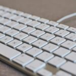Detailed image of a white computer keyboard with focus on keys, ideal for tech content.