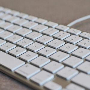 Detailed image of a white computer keyboard with focus on keys, ideal for tech content.